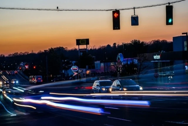 Cars streaking down a dimly lit street at dusk, Worst Thanksgiving Traffic